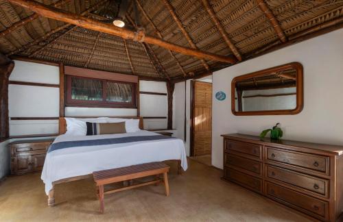 a bedroom with a bed and a wooden dresser at Punta Monterrey in Lo de Marcos