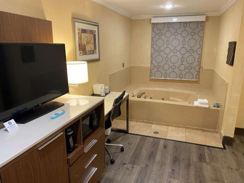 a bathroom with a television and a bath tub at Best Western Hollywood Plaza Inn Hotel - Hollywood Walk of Fame LA in Los Angeles