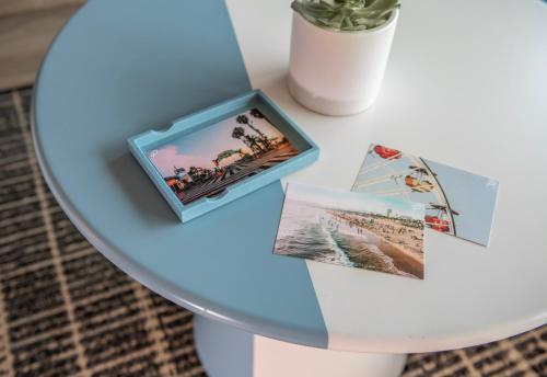 a table with a photograph and a box on it at The Pierside Santa Monica in Los Angeles