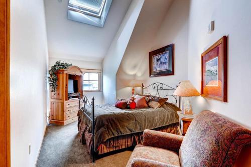 a bedroom with a bed and a couch in a room at Jackpine & Black Bear Condominiums by Keystone Resort in Keystone