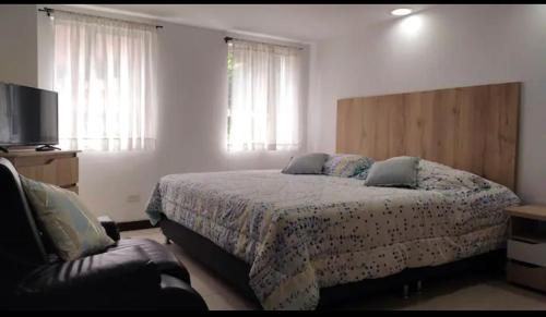 1 dormitorio con 1 cama y 1 sofá en CAMAKING /WIFI/ NETFLIX/ NORTE/ VALLEDEATRIZ/MODERNO, en Pasto
