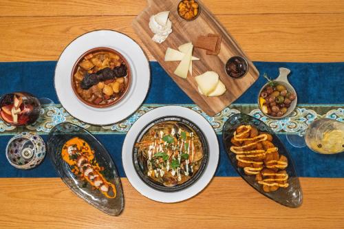 a table with bowls of food and plates of food at Hotel Shattuck Plaza in Berkeley