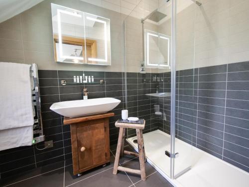 a bathroom with a sink and a shower at Padstow Escapes - Teyr Luxury Penthouse Apartment in Padstow