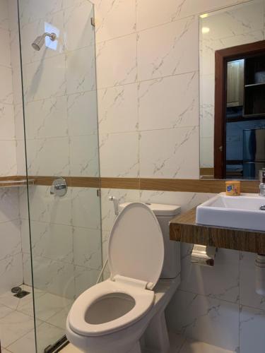 a bathroom with a toilet and a shower and a sink at Ptas Tauch Residence in Phnom Penh