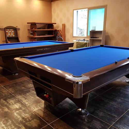 a pool table in a living room with at Mokkoji Pension in Hadong