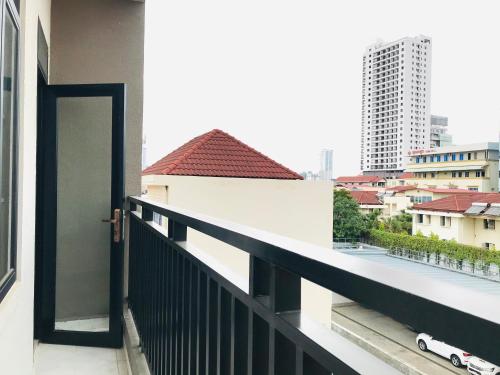 a door to a balcony with a view of a city at Ptas Tauch Residence in Phnom Penh