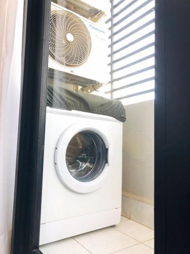 a washing machine with a fan on top of it at Ptas Tauch Residence in Phnom Penh