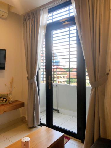 a room with a large glass door with a window at Ptas Tauch Residence in Phnom Penh