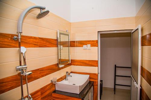 a bathroom with a sink and a mirror at Chala Villa in Ambalangoda