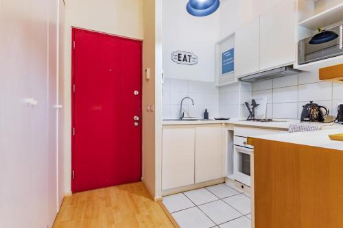 a red door in a kitchen with a counter at San Carlos rentals - Lastarria in Santiago