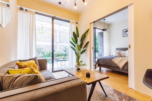 a living room with a couch and a bed at San Carlos rentals - Lastarria in Santiago