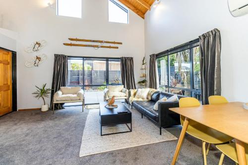 a living room with a couch and a table at Little Black Chalet Methven in Methven
