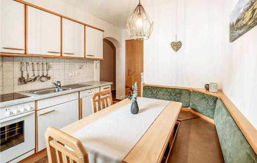 a kitchen with a wooden table and a sink at Cozy Apartment In Grossarl With House A Mountain View in Grossarl