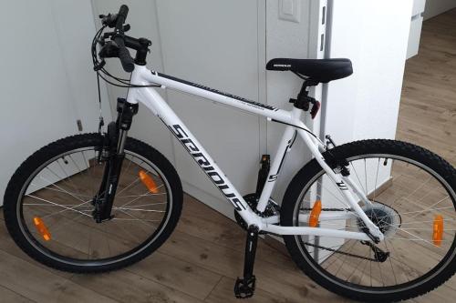a white bike parked next to a wall at Monforte charming 2-5Room Flat in Center TrulloVista in Monforte dʼAlba