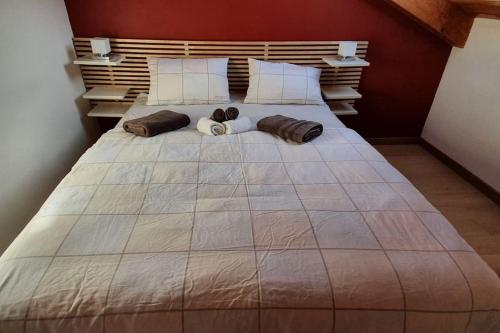 a large bed with two pillows on top of it at Monforte charming 2-5Room Flat in Center TrulloVista in Monforte dʼAlba