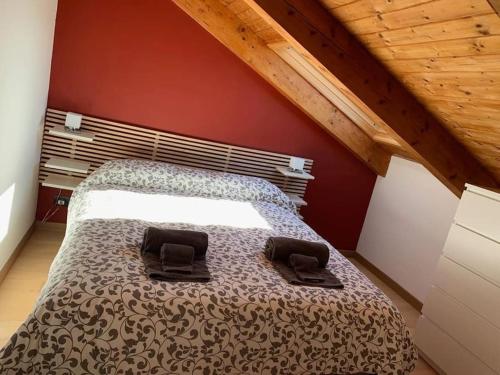 a bedroom with a bed with two shoes on it at Monforte charming 2-5Room Flat in Center TrulloVista in Monforte dʼAlba