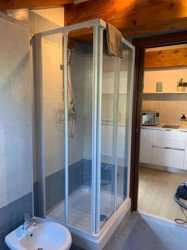 a bathroom with a shower and a toilet and a sink at Monforte charming 2-5Room Flat in Center TrulloVista in Monforte dʼAlba