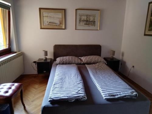 a bed in a room with two pillows on it at Holiday house with a parking space Jakovci Netreticki, Karlovac - 20279 in Netretić