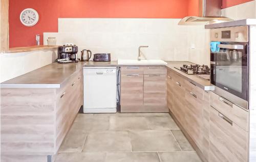 a kitchen with a white refrigerator and a sink at Cozy Home In La Souterraine in La Souterraine