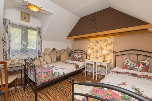 a bedroom with two beds and a couch in it at Family friendly house with a parking space Vranov Dol, Prigorje - 20590 in Jastrebarsko