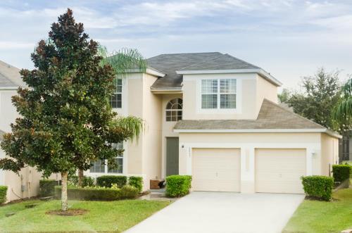 a house with a tree and a garage at Olivia's Dream Villa on WindsorHills in Orlando