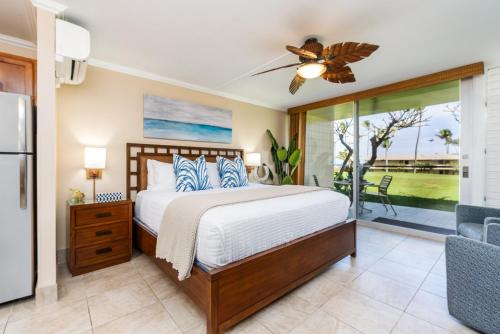 a bedroom with a bed and a sliding glass door at Napili Shores G157 condo in Kahana