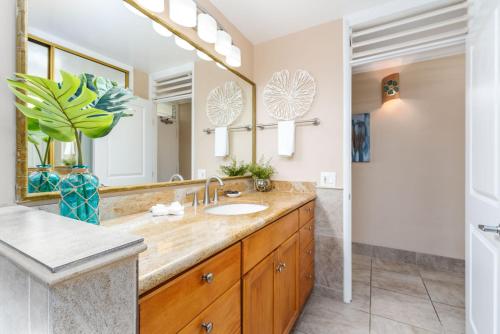 a bathroom with a sink and a large mirror at Napili Shores G157 condo in Kahana