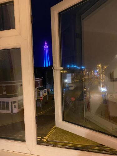a window with a view of a water tower at night at The Laurels in Blackpool