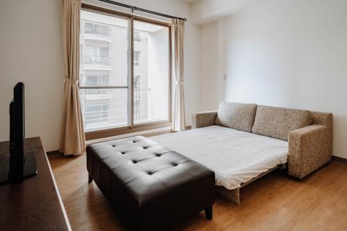 a living room with a couch and a window at LAR Suite in Taichung