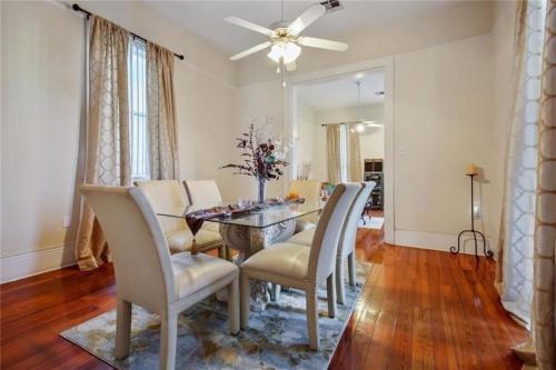 a dining room with a table and chairs at Historic Cottage 3 mins to the French Qtr. Sleeps 12 in New Orleans