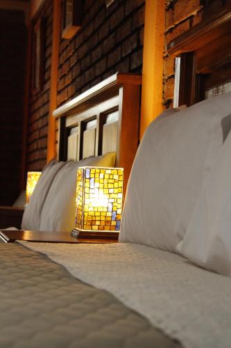 a bed with two pillows and a lamp on it at Casa Diez-59 Guanajuato Capital in Guanajuato