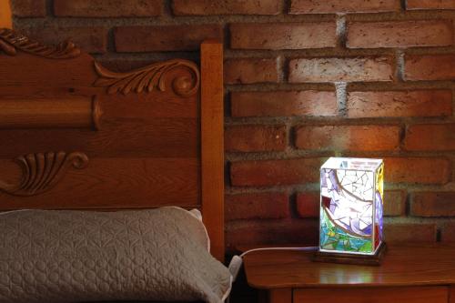 a lamp on a table next to a brick wall at Casa Diez-59 Guanajuato Capital in Guanajuato