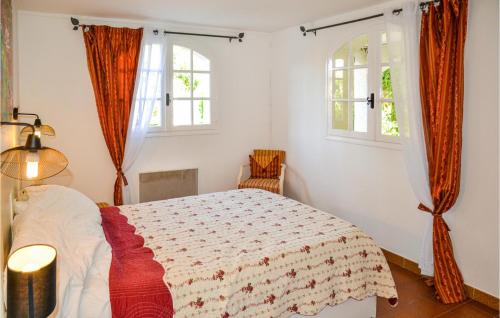 a bedroom with a bed and two windows at Beautiful Apartment In Pignan With Heated Swimming Pool in Pignan