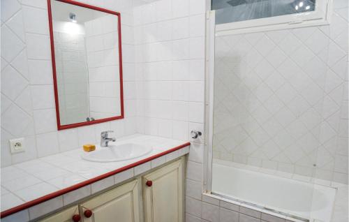 a bathroom with a sink and a shower with a mirror at Beautiful Apartment In Pignan With Heated Swimming Pool in Pignan