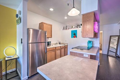 a kitchen with a stainless steel refrigerator and wooden cabinets at Parker Studio with Patio and Direct River Access! in Parker