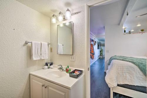 a bathroom with a sink and a bed in a room at Parker Studio with Patio and Direct River Access! in Parker