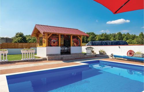 a swimming pool with a gazebo next to a house at Awesome Home In Gospic With Sauna in Gospić