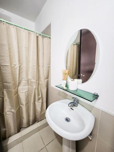 a bathroom with a sink and a mirror at The Besh Place - Baguio City in Baguio