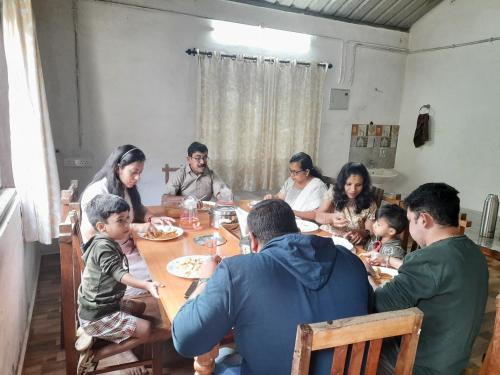 a group of people sitting around a table eating at Sopanam Heritage Thekkady in Thekkady