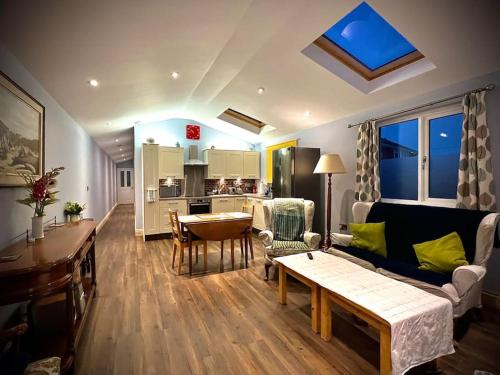 a living room with a couch and a table at Countryside in the Town. in Harlescott