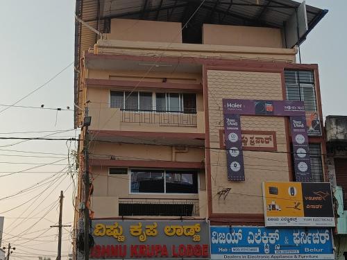 a building with signs on the side of it at Sri vishnu krupa lodging in Belūr