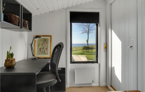 a home office with a desk and a window at Amazing Home In Mesinge With Kitchen in Mesinge
