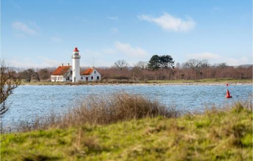 a lighthouse on the shore of a body of water at Amazing Home In Mesinge With Kitchen in Mesinge