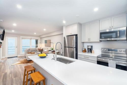 una cucina con armadi bianchi e piano di lavoro bianco di Perfect Location! King Bed, Full Kitchen, Walk to Gondola condo a Telluride