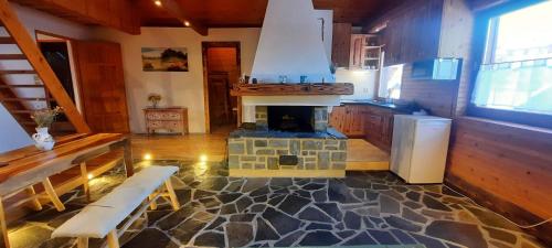 a kitchen with a stone floor and a stove at Podkrovie v zeleni - privat in Štrba