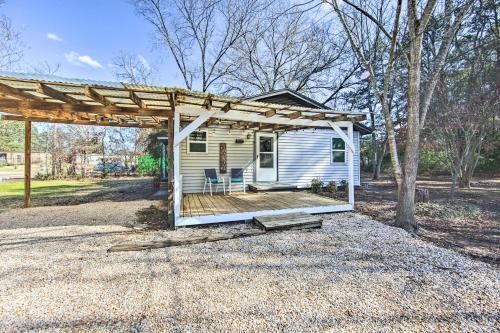 a tiny house with a porch and a pergola at Longview Vacation Rental Home 4 Mi to Dtwn in Longview