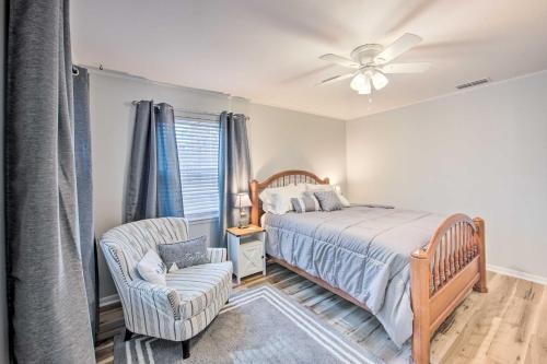 a bedroom with a bed and a chair and a ceiling fan at Longview Vacation Rental Home 4 Mi to Dtwn in Longview