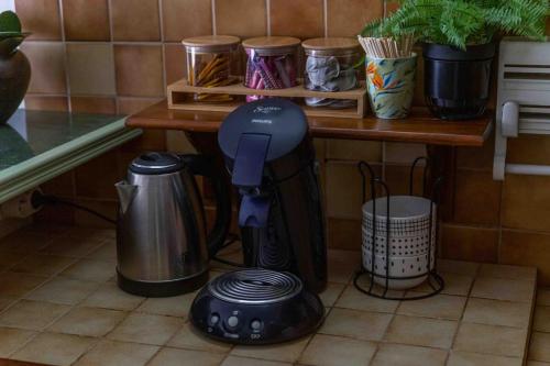 a blender sitting on the floor next to a table at Le cosy : proche cdg-parc des expo-Paris-Disney in Sevran