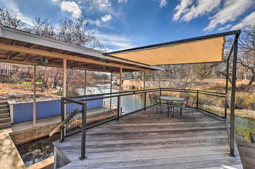 a deck with a table and chairs on it at Lake LBJ Waterfront Vacation Rental! in Granite Shoals
