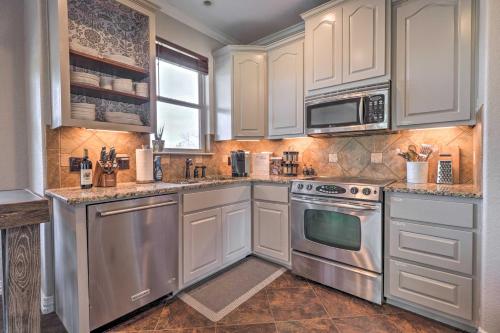 a kitchen with white cabinets and stainless steel appliances at Lake LBJ Waterfront Vacation Rental! in Granite Shoals